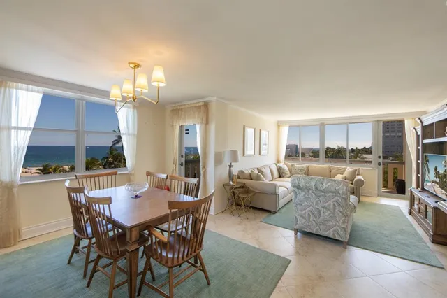 a living room with furniture and a book shelf