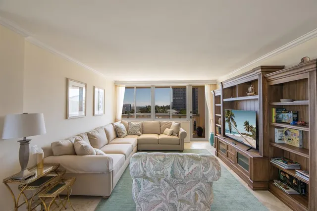 a dining room with wooden floor a chandelier a wooden table and chairs