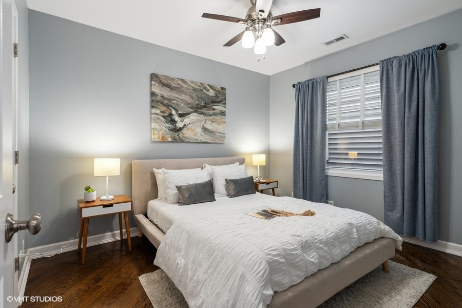 1219 West Melrose Street, Unit 2 Chicago, IL 60657 - Photo 11 of 13 a bedroom with a large bed and a chandelier