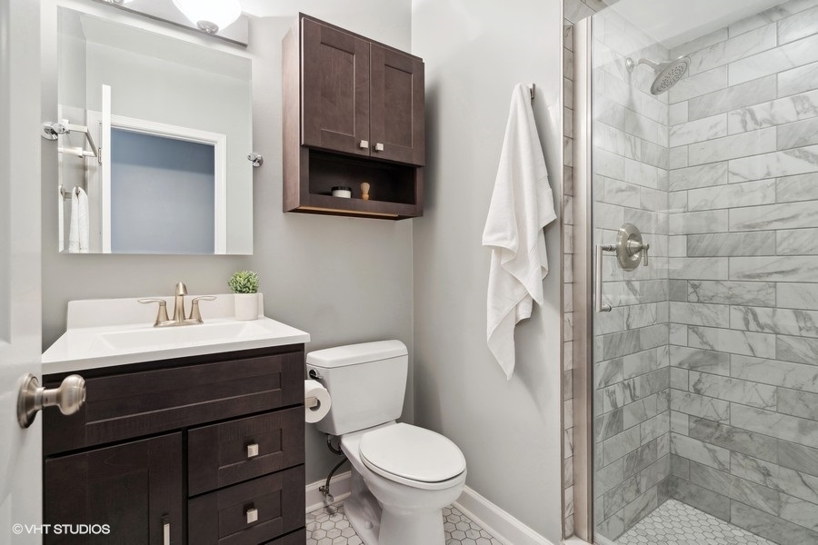 1219 West Melrose Street, Unit 2 Chicago, IL 60657 - Photo 12 of 13 a bathroom with a toilet sink and mirror