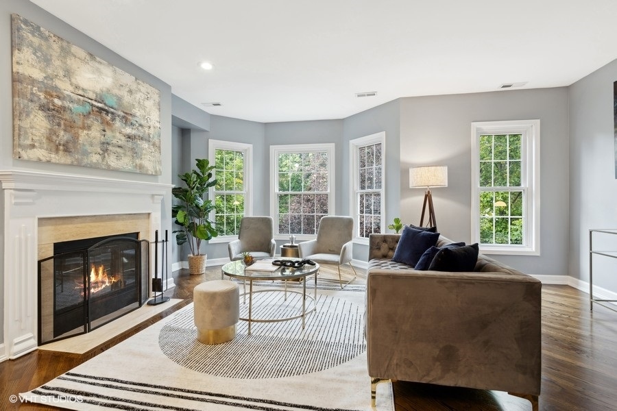 1219 West Melrose Street, Unit 2 Chicago, IL 60657 - Photo 5 of 13 a living room with furniture a large window and a fireplace