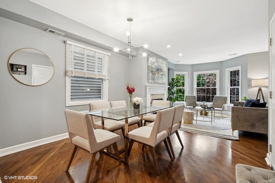 1219 West Melrose Street, Unit 2 Chicago, IL 60657 - Photo 6 of 13 a view of a dining room with furniture window and wooden floor