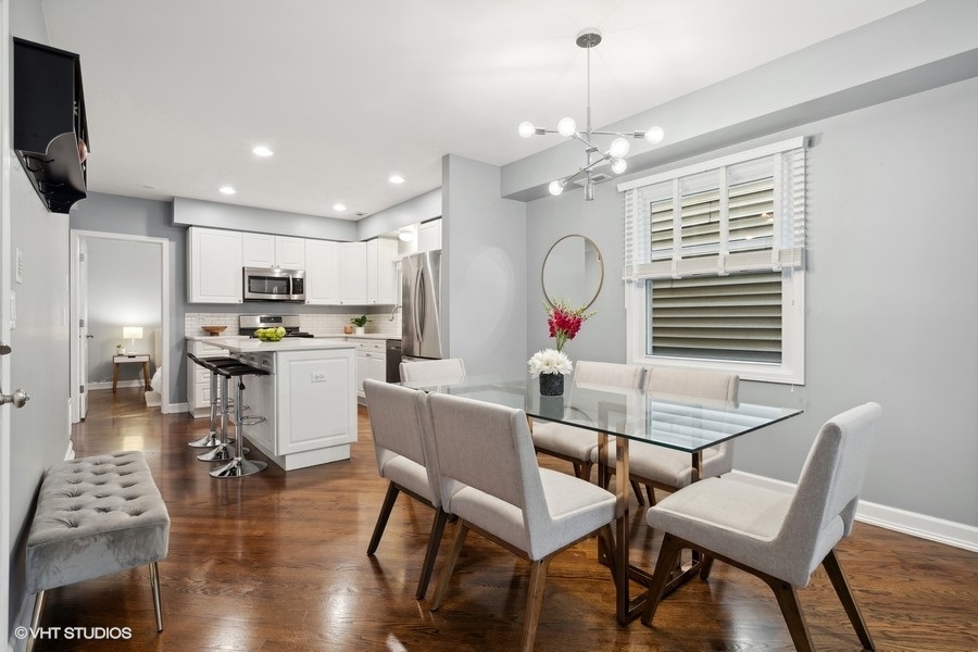1219 West Melrose Street, Unit 2 Chicago, IL 60657 - Photo 7 of 13 a view of a dining room with furniture window and wooden floor