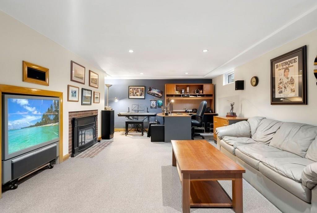 2 Lexington Avenue Lexington, MA 02421 - Photo 33 of 39 a living room with furniture flat screen tv and fireplace