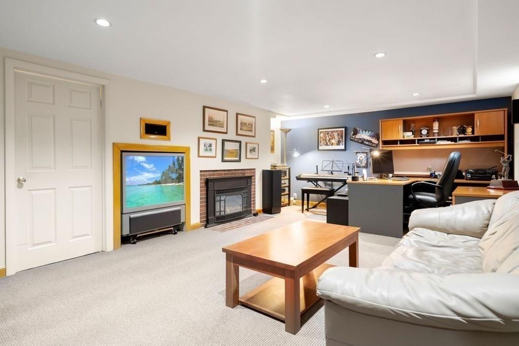 2 Lexington Avenue Lexington, MA 02421 - Photo 34 of 39 a living room with furniture and a fireplace