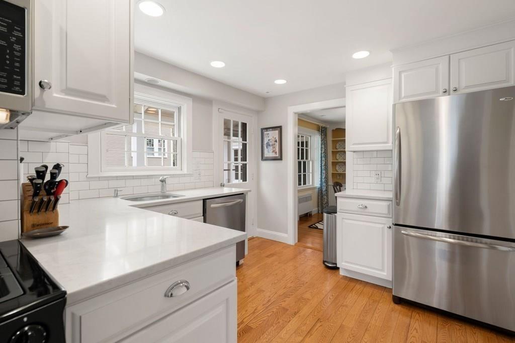 2 Lexington Avenue Lexington, MA 02421 - Photo 10 of 39 a kitchen with a refrigerator a sink and a stove top oven