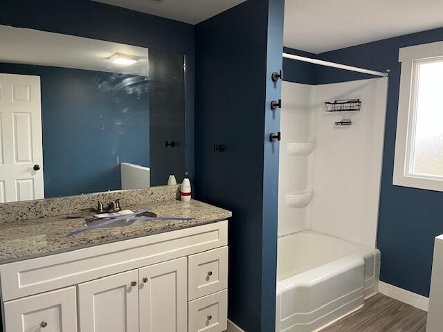 407 East State Street Morocco, IN 47963 - Photo 7 of 18 a bathroom with a granite countertop sink a toilet and bathtub