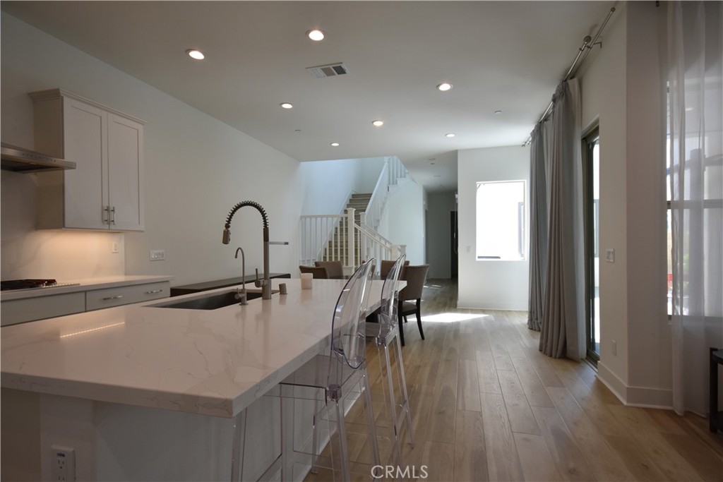 364 Baluster Irvine, CA 92618 - Photo 12 of 56 a open kitchen with stainless steel appliances a table chairs refrigerator and sink