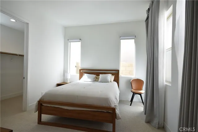 a bedroom with a bed and a large mirror