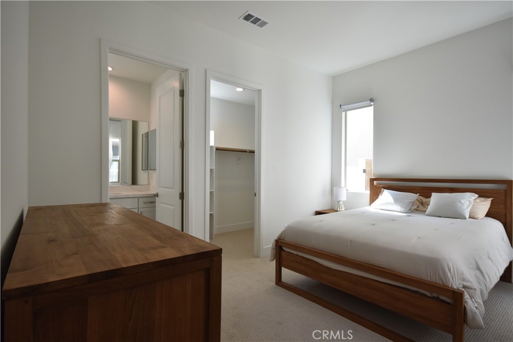 364 Baluster Irvine, CA 92618 - Photo 20 of 56 a bedroom with a bed and a large mirror