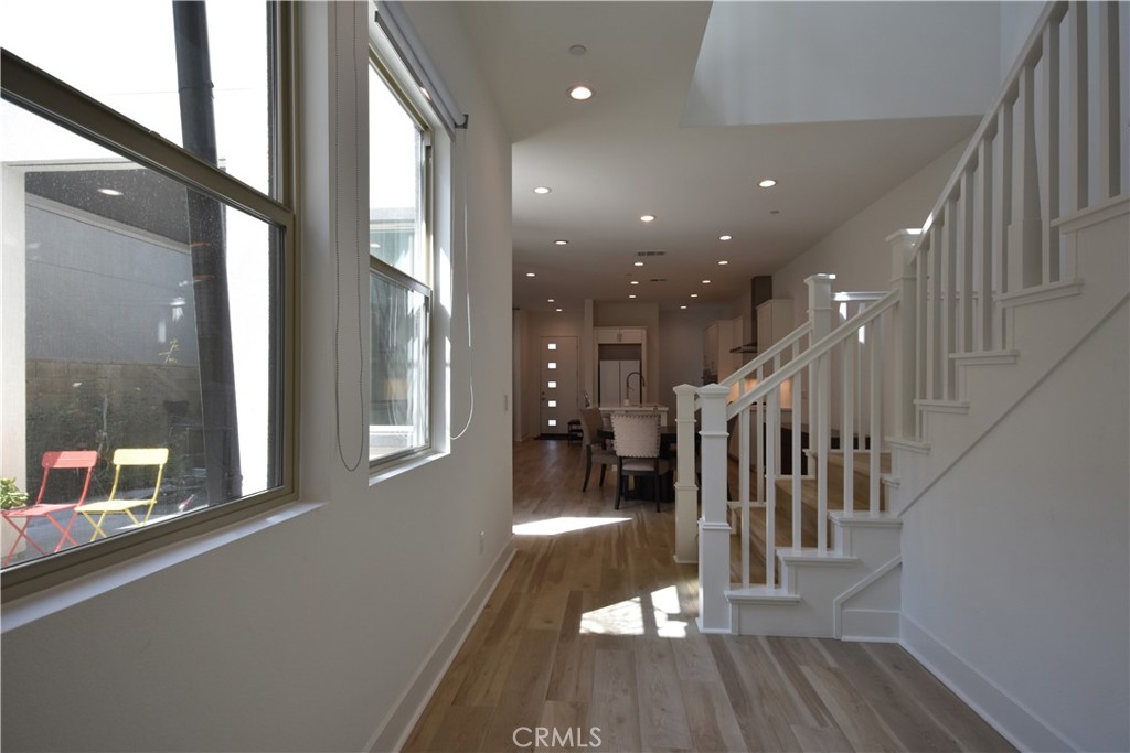 364 Baluster Irvine, CA 92618 - Photo 25 of 56 a view of a hallway with wooden floor and door