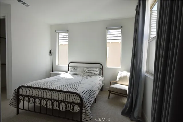 a bedroom with bed and window