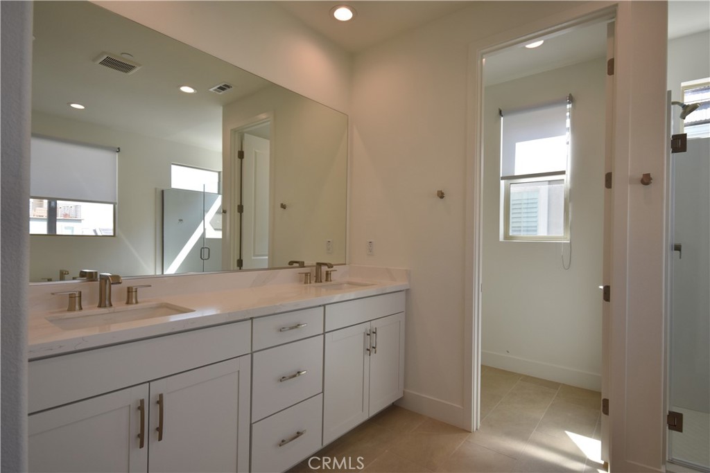 364 Baluster Irvine, CA 92618 - Photo 49 of 56 a bathroom with double sink and a mirror