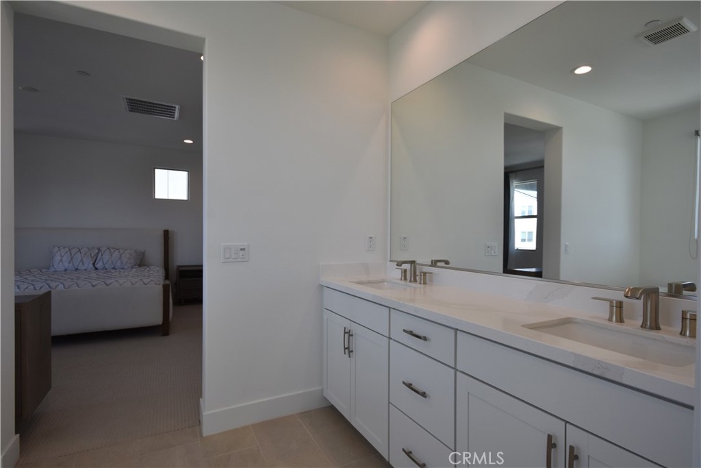 364 Baluster Irvine, CA 92618 - Photo 50 of 56 a bathroom with a double vanity sink and mirror