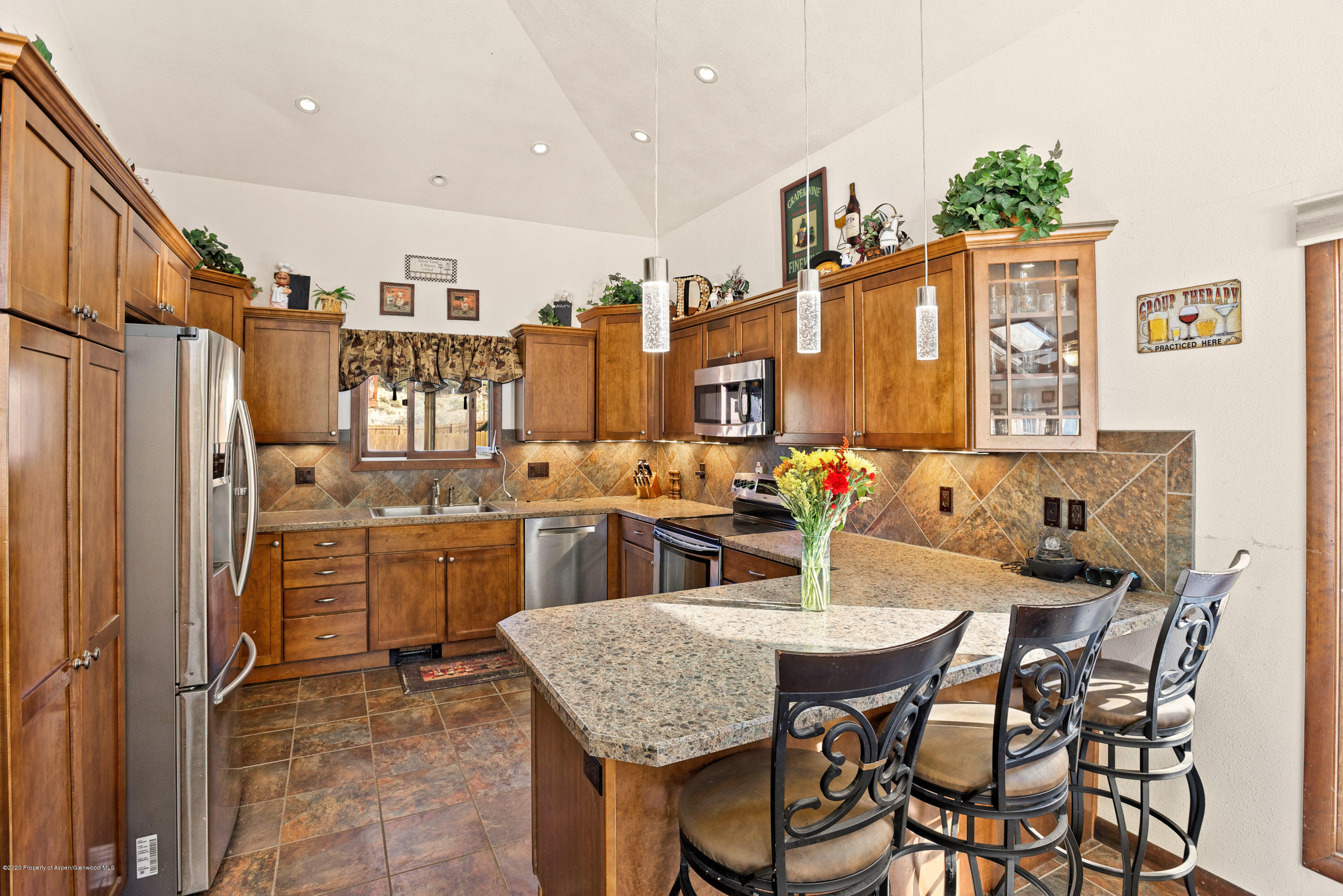 690 Moki Avenue Rifle, CO 81650 - Photo 1 of 15 a view of a dining room with furniture and a kitchen