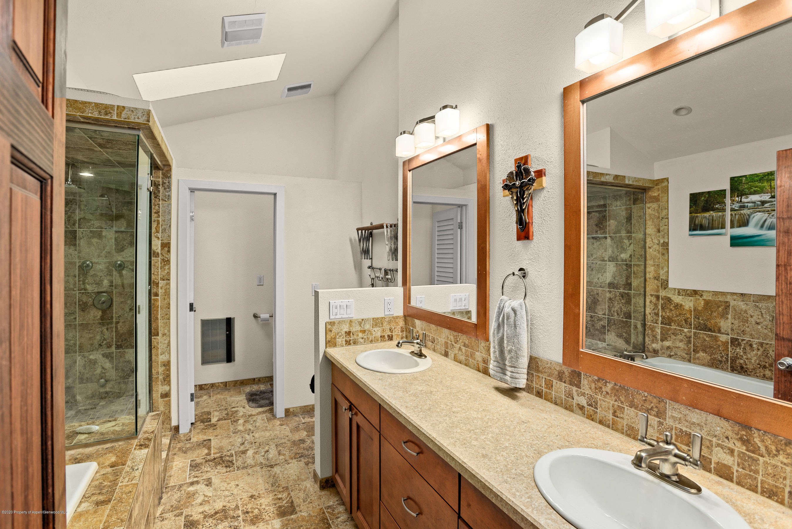 690 Moki Avenue Rifle, CO 81650 - Photo 8 of 15 a bathroom with a granite countertop sink and a mirror