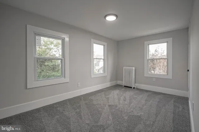 an empty room with windows and closet