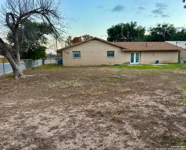 a view of house with backyard space
