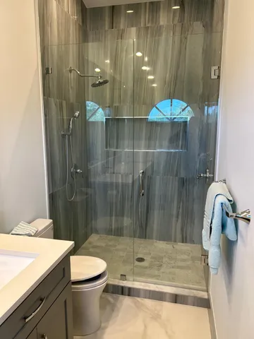 a bathroom with a shower and a sink