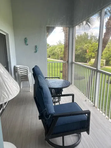 a balcony with furniture and wooden floor
