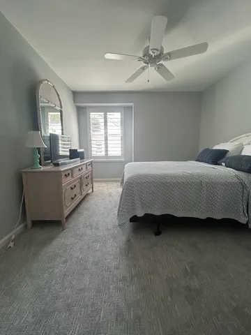 a spacious bedroom with a bed and window