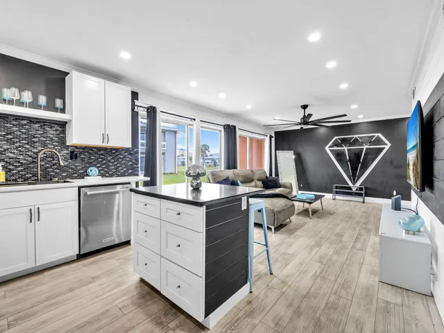a kitchen with a sink cabinets and wooden floor