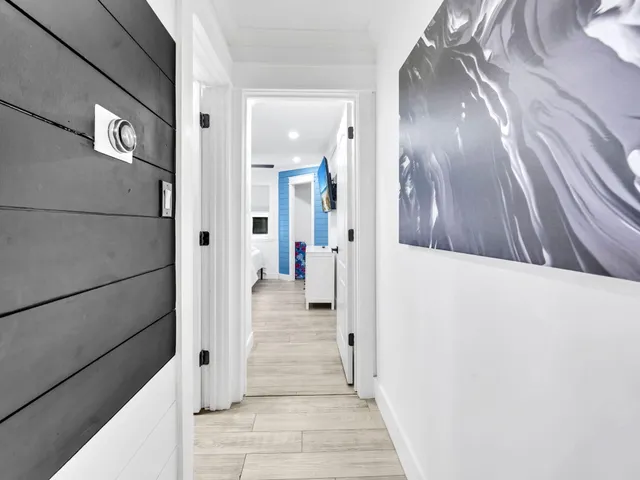 a view of a hallway with wooden floor and staircase