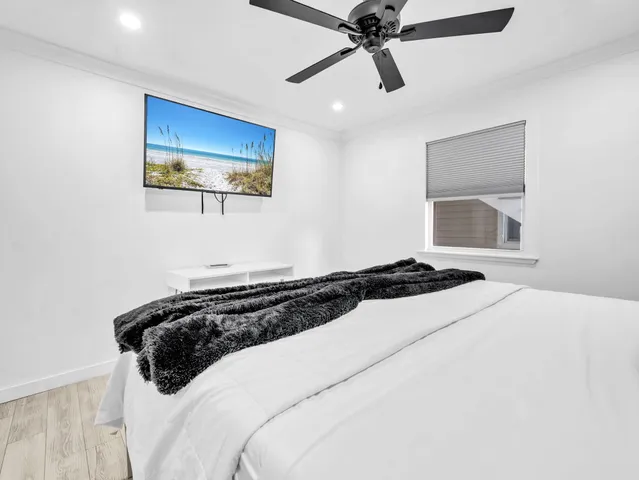 a bedroom with a large bed and a chandelier