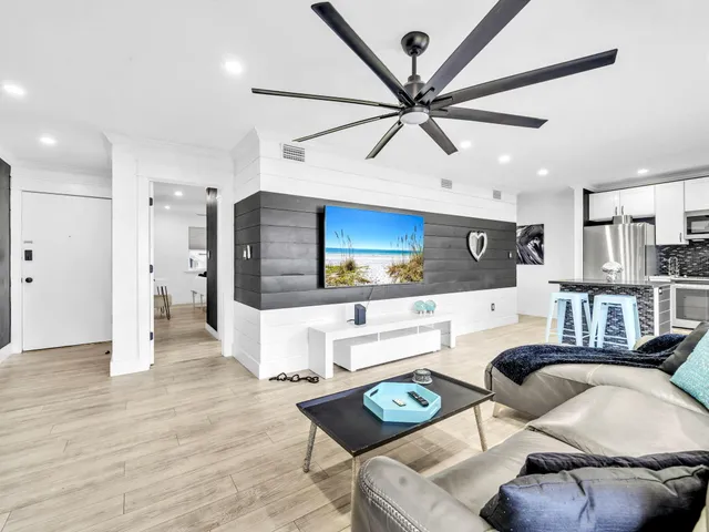 a living room with furniture and kitchen view