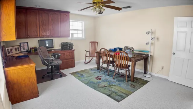 a view of a dining room with a table and chairs