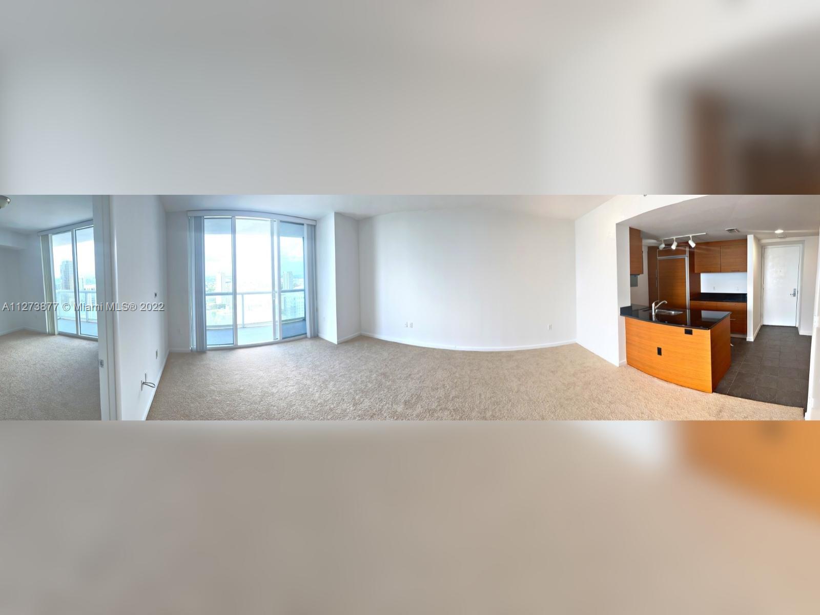 50 Biscayne Boulevard, Unit 5005 Miami, FL 33132 - Photo 6 of 20 a living room with furniture and window with kitchen view