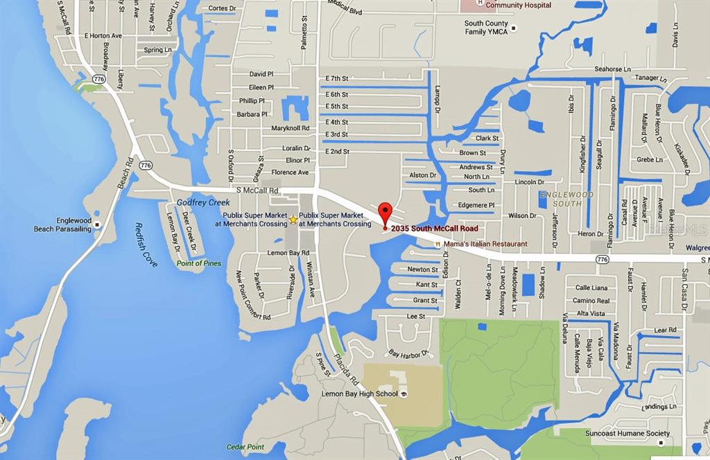 2035 South McCall Road Englewood, FL 34223 - Photo 14 of 17 a utility room with fridge dryer and washer