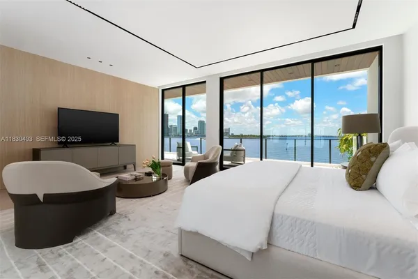 a bedroom with a bed and large window