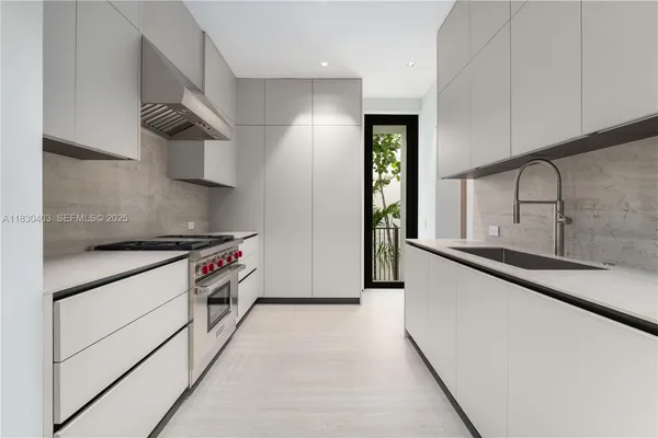 a kitchen with stainless steel appliances a sink and a stove