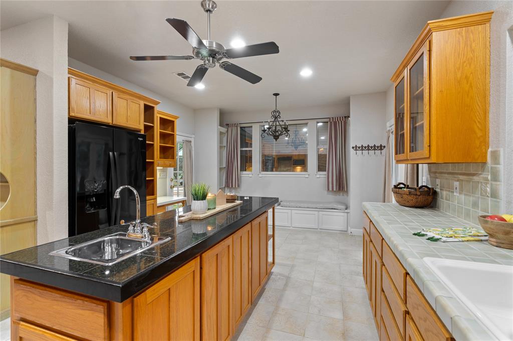 400 Indian Hills Road Gatesville, TX 76528 - Photo 13 of 38 a kitchen with stainless steel appliances granite countertop a sink stove and refrigerator