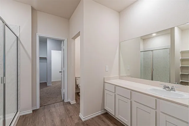 a bathroom with a double vanity sink and mirror