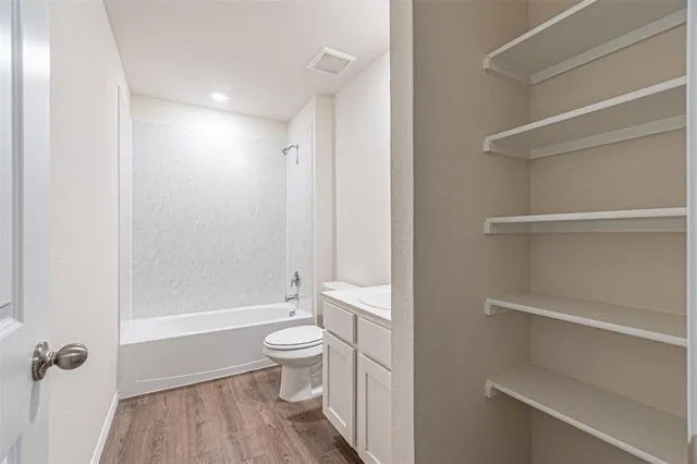 a bathroom with a toilet a sink and bathtub