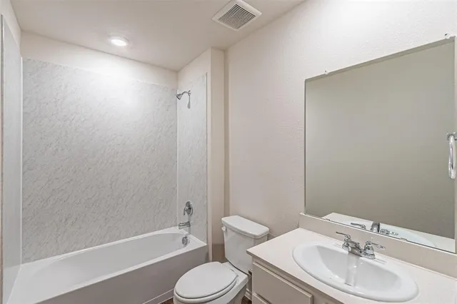 a bathroom with a toilet a sink and bathtub