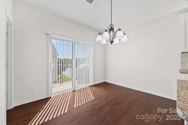 a open kitchen with white cabinets and stainless steel appliances