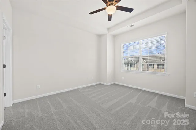 a view of a livingroom with a ceiling fan and entryway