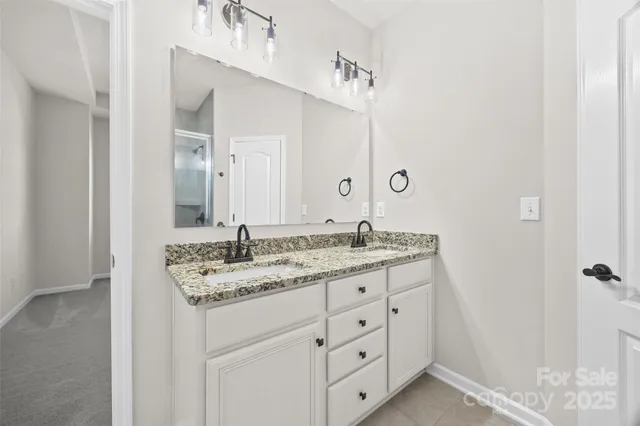 a bathroom with a glass shower door