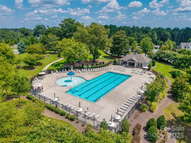 an aerial view of a house with a swimming pool