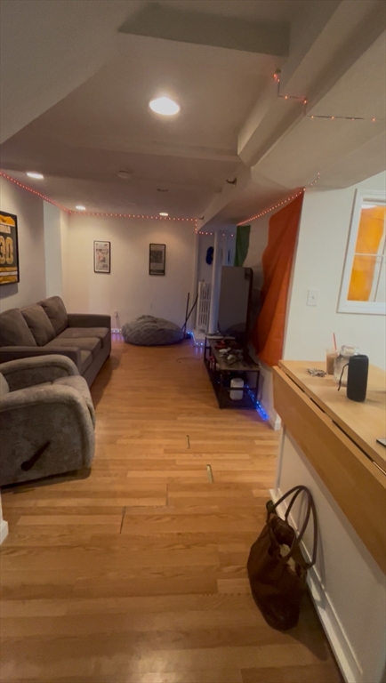 63 Hancock, Unit BR Boston, MA 02114 - Photo 2 of 12 a bed room with furniture and gym equipment