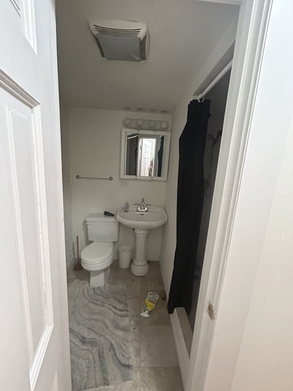 63 Hancock, Unit BR Boston, MA 02114 - Photo 9 of 12 a bathroom with a toilet and a shower