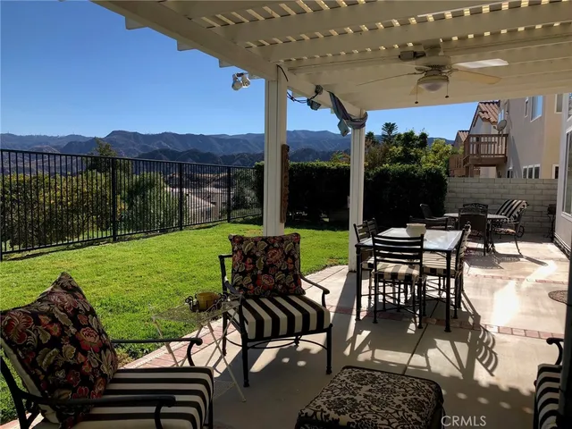 a view of a chairs and table in patio with a yard
