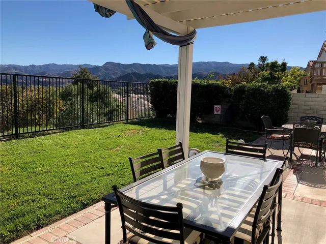 a view of a patio with a table chairs and a table