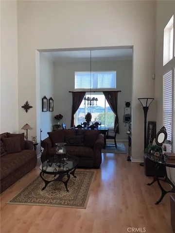 a living room with furniture and a mirror