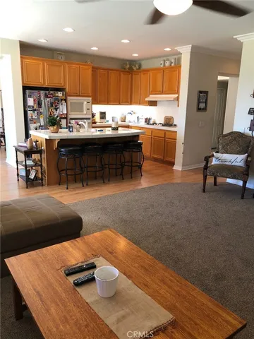 a kitchen with stainless steel appliances granite countertop a sink and a refrigerator