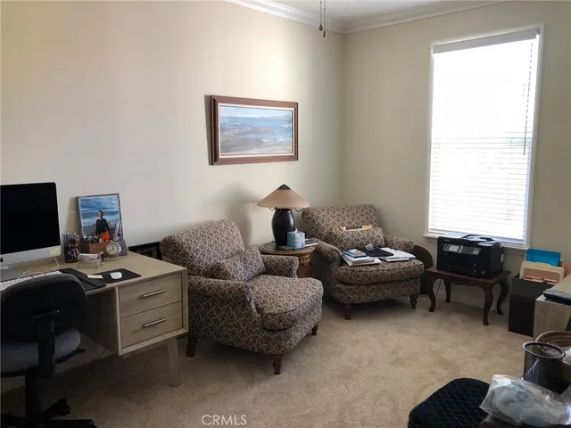 a living room with furniture a window and a flat screen tv