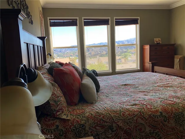 a bed sitting in a bedroom next to a window